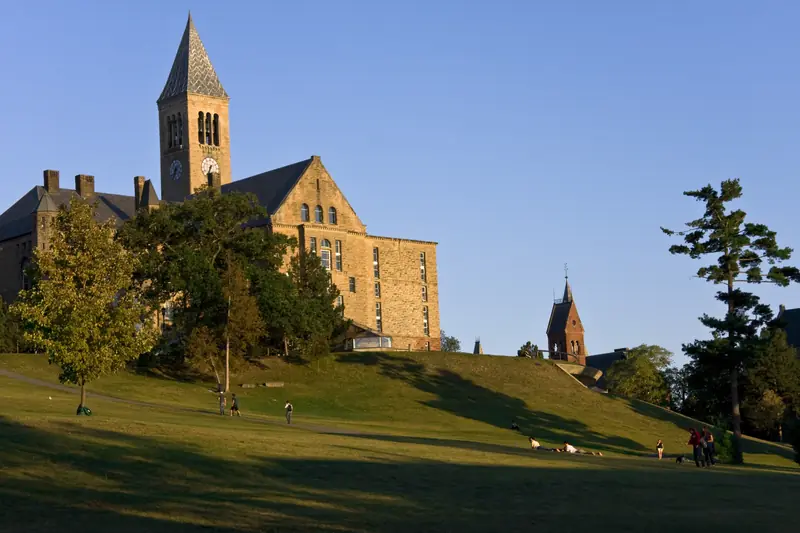 McGraw Tower and Uris Library at Cornell University in Ithaca, New York, above Libe Slope at golden hour.