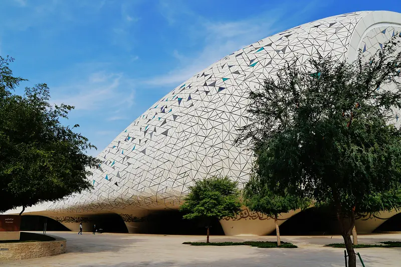 The Education City Mosque in Doha, its white lattice shell rising above the trees.