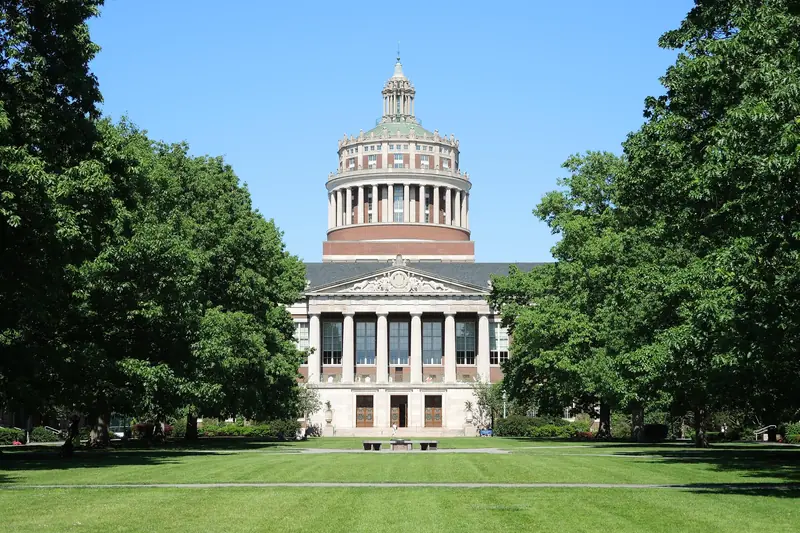 Rush Rhees Library at the University of Rochester, its domed tower rising above the long lawn of the Eastman Quadrangle.