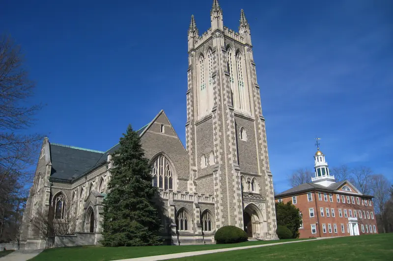 Thompson Memorial Chapel at Williams College in Williamstown, Massachusetts, its stone tower against a deep blue sky.